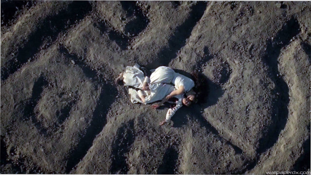 Man laying sand cellphone hands free wallpaper for desktop - medium preview image