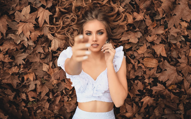 Woman pointing phone autumn leaves free wallpaper for desktop - medium preview image