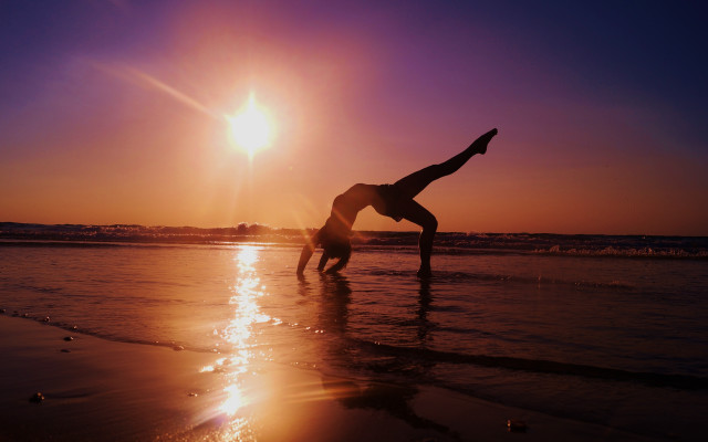 Beach sunset handstand silhouette ocean free wallpaper for desktop - medium preview image