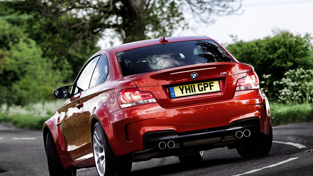 Red car forest road cherryblossoms free wallpaper for desktop - medium preview image