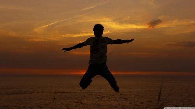 Man jumping sunset arms outstretched free wallpaper for desktop - medium preview image