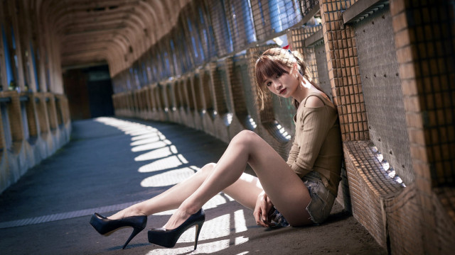 Woman highheels greenshirt sitting wall free wallpaper for desktop - medium preview image