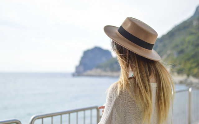 Woman hat ocean balcony cliff free wallpaper for desktop - medium preview image