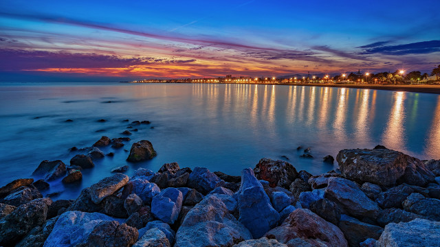 Sunset rocky beach cityscape water free wallpaper for desktop - medium preview image