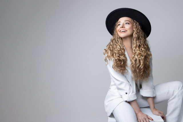 Woman blonde hat sitting blue free wallpaper for desktop - medium preview image