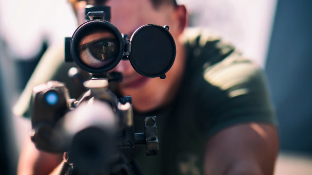 Man aiming gun scoped microscopic free wallpaper for desktop - medium preview image