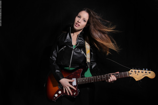 Woman guitar posing black background free wallpaper for desktop - medium preview image