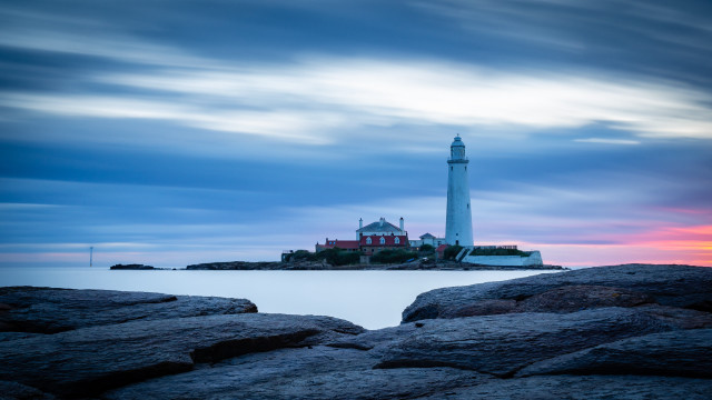 Lighthouse rocky shore sunset cloudy free wallpaper for desktop - medium preview image