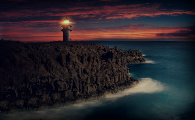 Lighthouse cliff red sky water free wallpaper for desktop - medium preview image