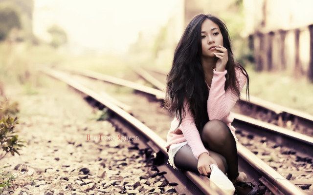 Woman sitting train track smiling free wallpaper for desktop - medium preview image