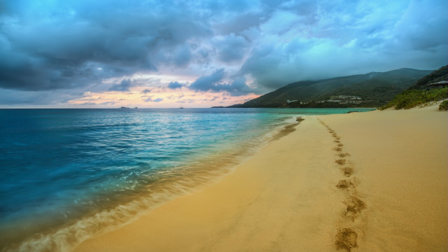 Beach footprints mountain clouds ocean free wallpaper for desktop - medium preview image