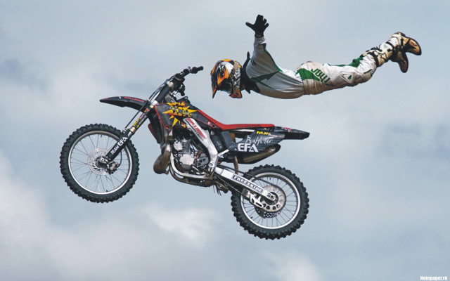 Man flying motorcycle helmet gloves free wallpaper for desktop - medium preview image