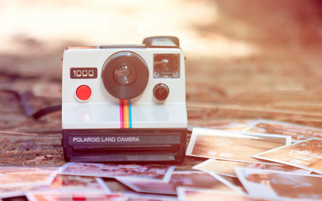 Polaroid camera pile pictures blurry free wallpaper for desktop - medium preview image