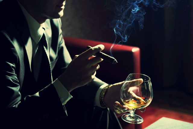 Man suit smoking cigarette holding free wallpaper for desktop - medium preview image