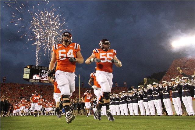 Football players running fireworks crowd free wallpaper for desktop - medium preview image