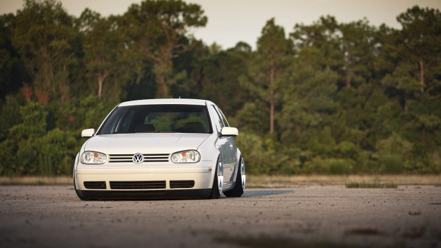 White car parked next to free wallpaper for desktop - medium preview image