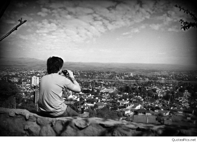 Man sitting rock city camera free wallpaper for desktop - medium preview image