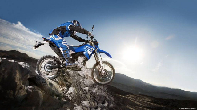 Man riding dirt bike mountain free wallpaper for desktop - medium preview image
