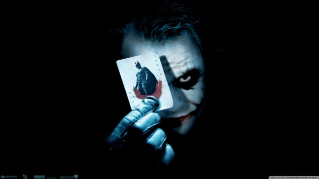 Joker holding card evil look free wallpaper for desktop - medium preview image