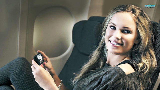 Woman chair cellphone smiling camera free wallpaper for desktop - medium preview image