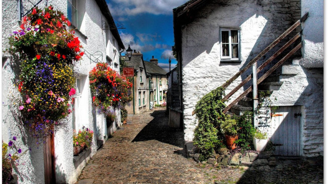 Narrow street flowers buildings clouds free wallpaper for desktop - medium preview image