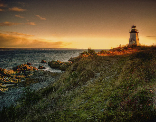 Lighthouse cliff ocean sunset sunrise free wallpaper for desktop - medium preview image