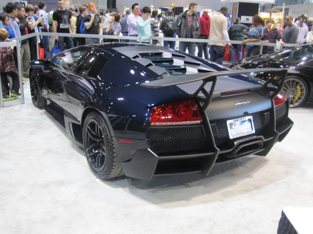 Black sports car showroom crowd free wallpaper for desktop - medium preview image