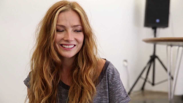 Woman smiling camera speaker table free wallpaper for desktop - medium preview image