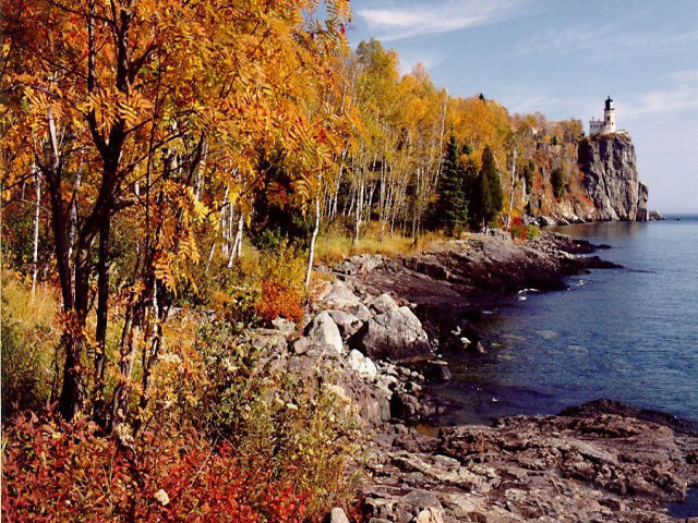 Lighthouse rocky shore autumn impressionist free wallpaper for desktop - medium preview image