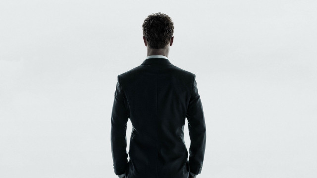 Man suit looking distance back free wallpaper for desktop - medium preview image