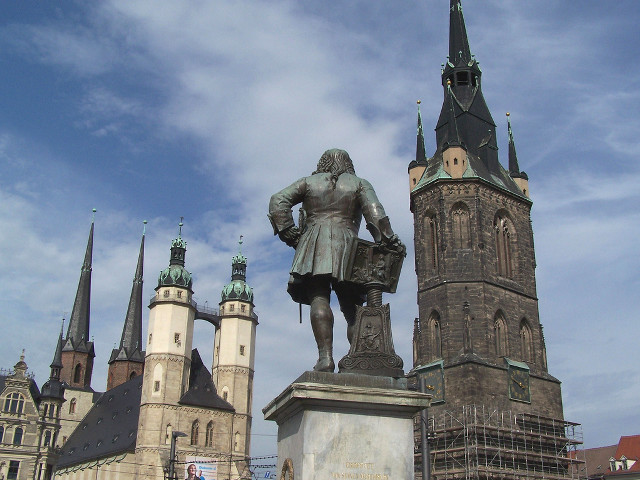 Statue man tall building clock free wallpaper for desktop - medium preview image