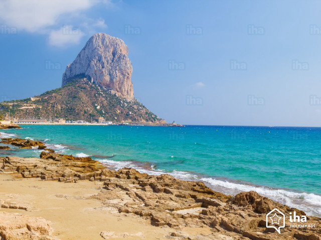 Rocky beach mountain blue water free wallpaper for desktop - medium preview image