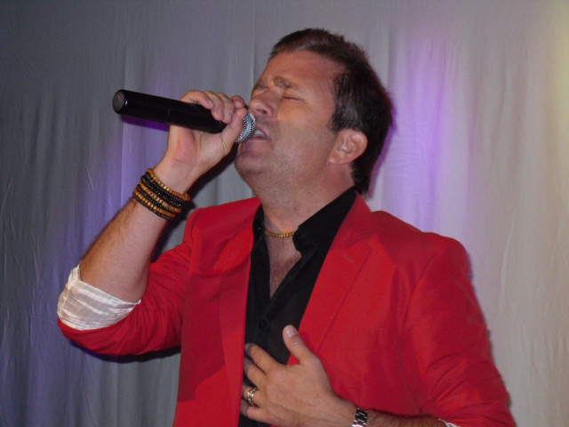 Man red suit singing microphone free wallpaper for desktop - medium preview image