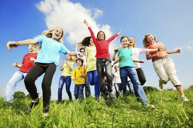 Young people jumping field grass free wallpaper for desktop - medium preview image