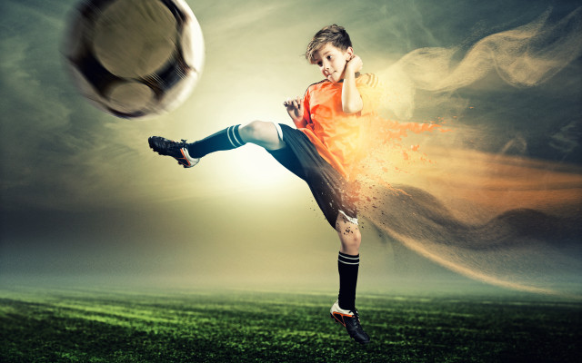 Young boy kicking soccer ball free wallpaper for desktop - medium preview image