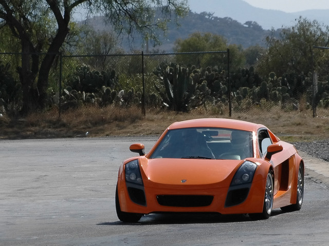 Orange sports car driving street free wallpaper for desktop - medium preview image