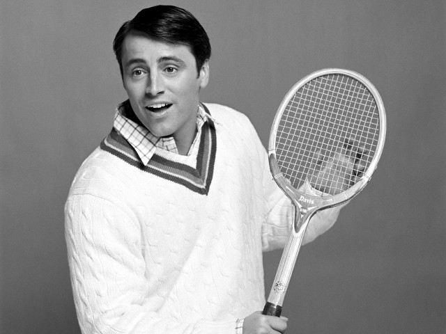 Man holding tennis racket smiling free wallpaper for desktop - medium preview image