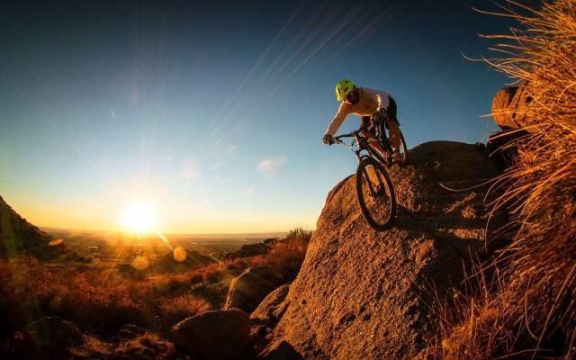 Man bike rocky hillside sunset #2 free wallpaper for desktop - medium preview image