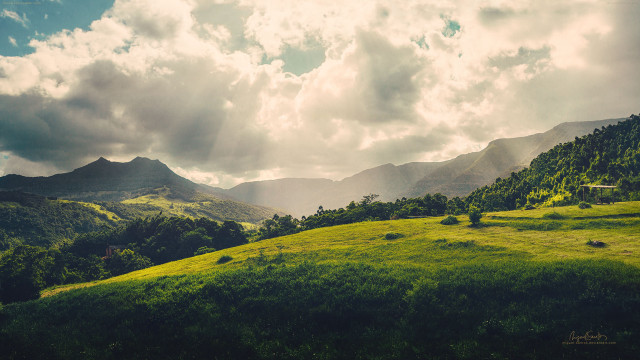 Lush green hillside cloudy sky free wallpaper for desktop - medium preview image