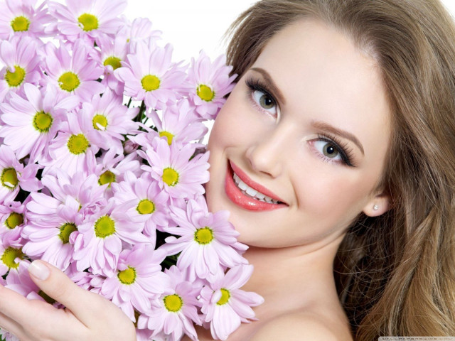 Woman holding flowers smiling camera #4 free wallpaper for desktop - medium preview image