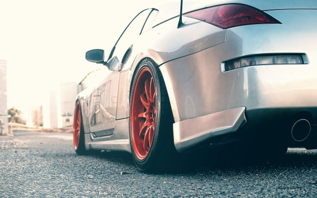 Car parked red rims road free wallpaper for desktop - medium preview image