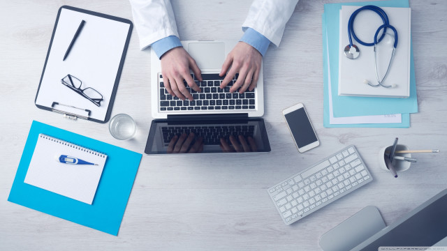 Person typing laptop medical office free wallpaper for desktop - medium preview image