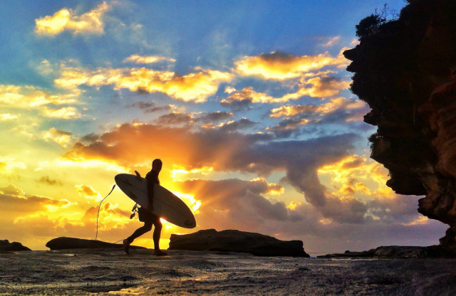 Person walking beach surfboard cloudy free wallpaper for desktop - medium preview image