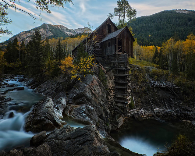 Wooden building rocky hillside river free wallpaper for desktop - medium preview image