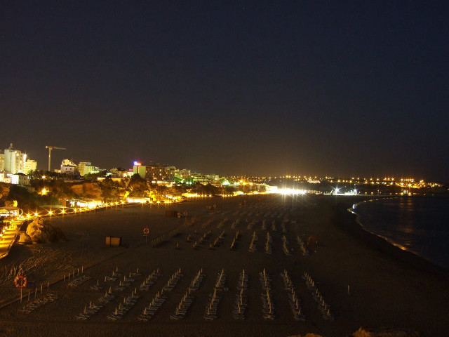 Beach chairs tables nighttime city free wallpaper for desktop - medium preview image