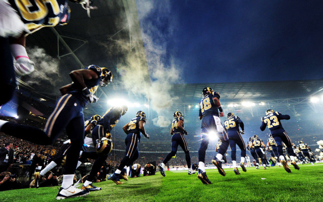 Football players night field lights free wallpaper for desktop - medium preview image