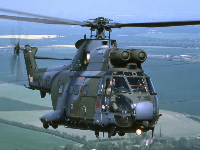 Helicopter flying lush green countryside free wallpaper for desktop - medium preview image