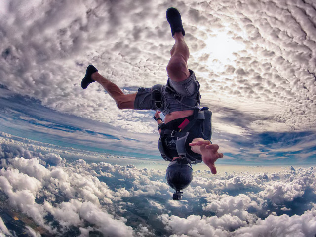 Man skydiving clouds feet up free wallpaper for desktop - medium preview image