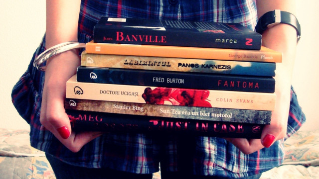 Woman holding stack of books free wallpaper for desktop - medium preview image