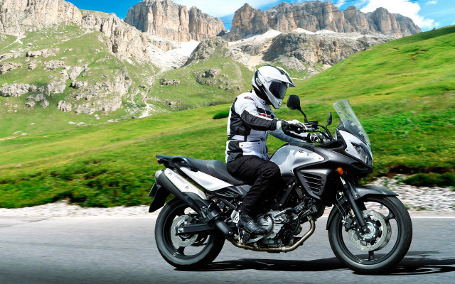 Man motorcycle road green hillside free wallpaper for desktop - medium preview image